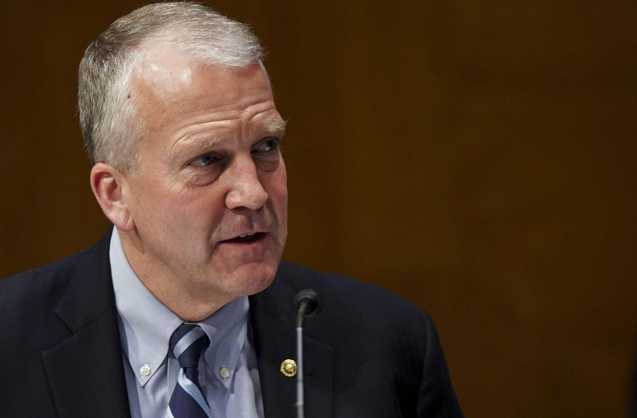 Dan Sullivan looking smug at a congressional podium